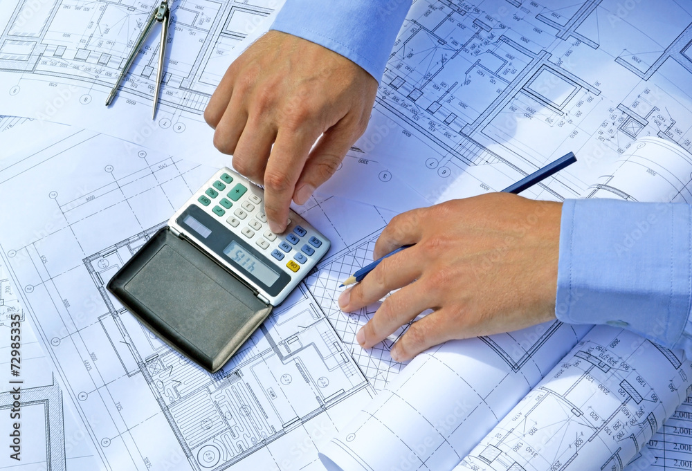 Hands with tool and project drawings Hands with tool and project drawings