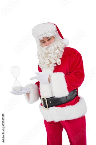 Smiling santa claus holding hourglass