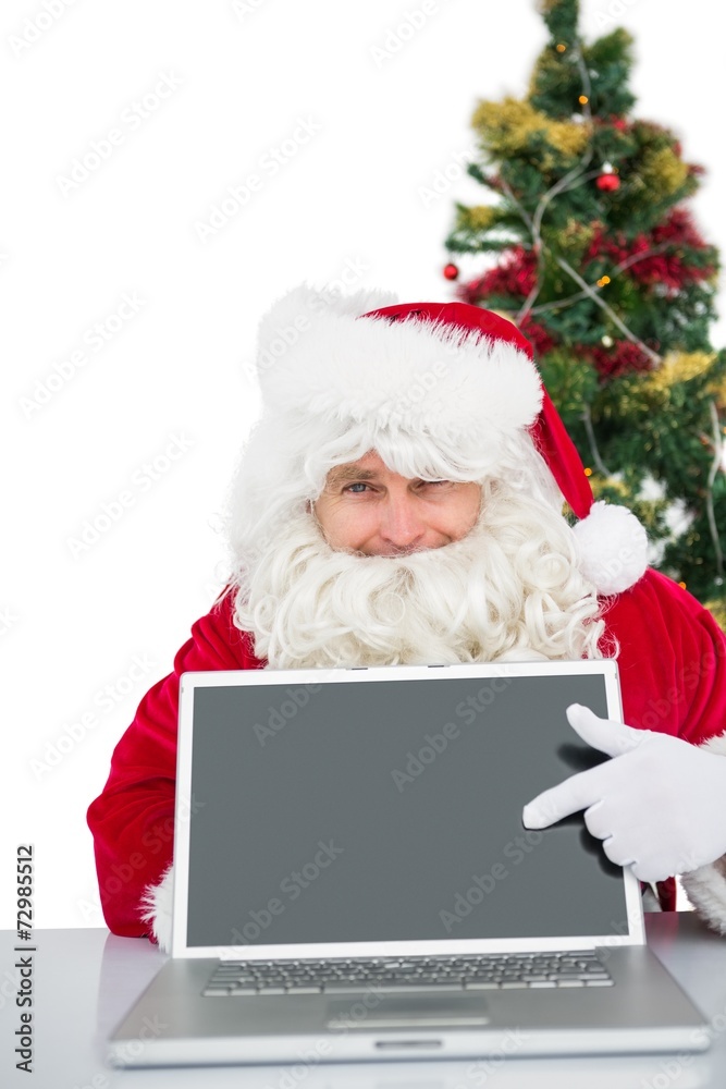 Santa claus showing his laptop Santa claus showing his laptop