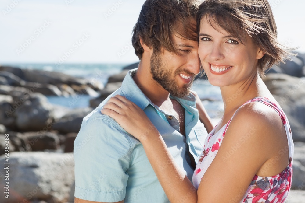 Gorgeous couple embracing by the coast Gorgeous couple embracing by the coast