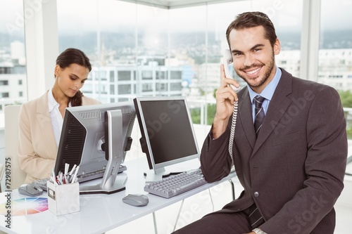 Business people using computers in office