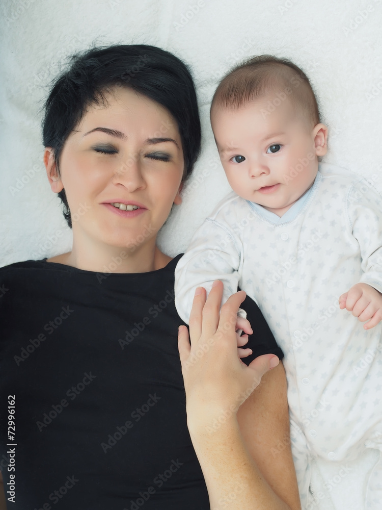 Happy caucasian family lying on the bed at home Happy caucasian family lying on the bed at home
