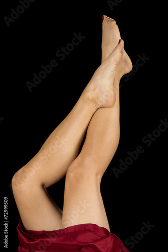 woman legs and a red sheet both legs up foot crossed
