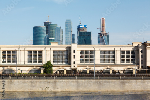 Power station at embankment and skyscrapers