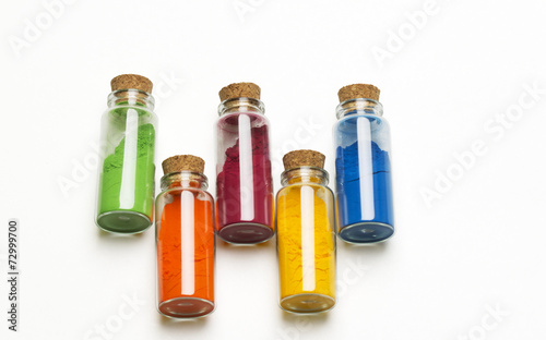 Glass bottles filed with colored powder