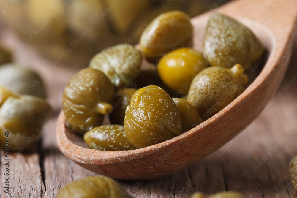 ripe capers in a wooden spoon macro horizontal ripe capers in a wooden spoon macro horizontal