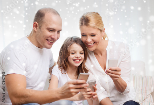 happy family with smartphones at home