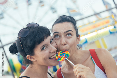 Happy Young Women eating Lollipop