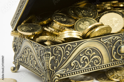 gold casket and gold coins on a white background