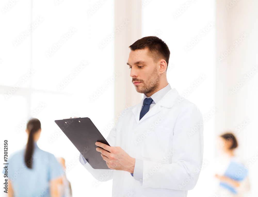 serious male doctor with clipboard serious male doctor with clipboard