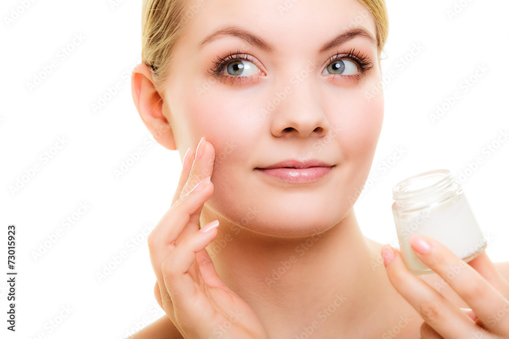 Skin care. Girl applying moisturizing cream.
