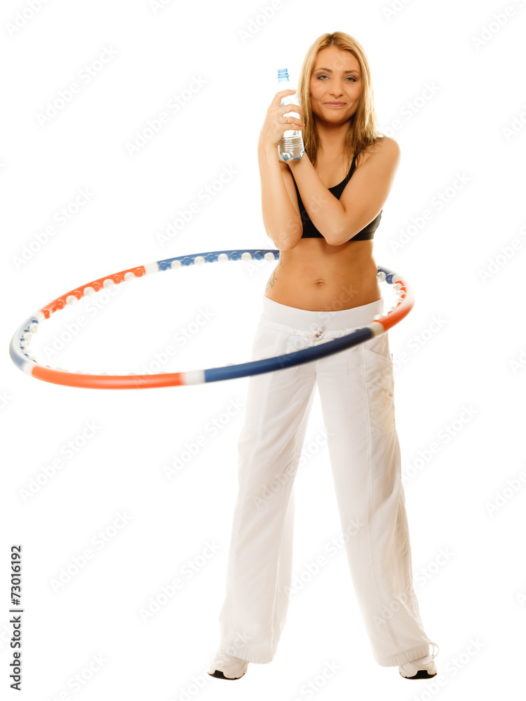 sporty fit girl doing exercise with hula hoop.