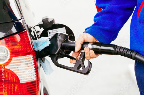 transportation and ownership concept - man pumping gasoline fuel