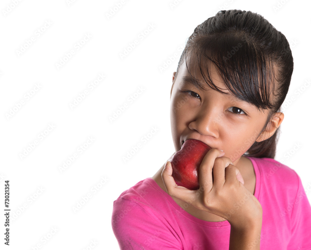 Young Asian teen eating a red apple over white background Young Asian teen eating a red apple over white background