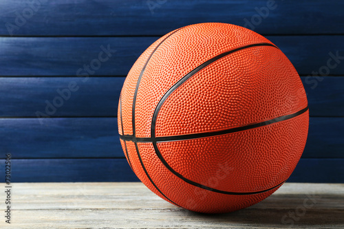 Basketball ball on wooden background © Africa Studio