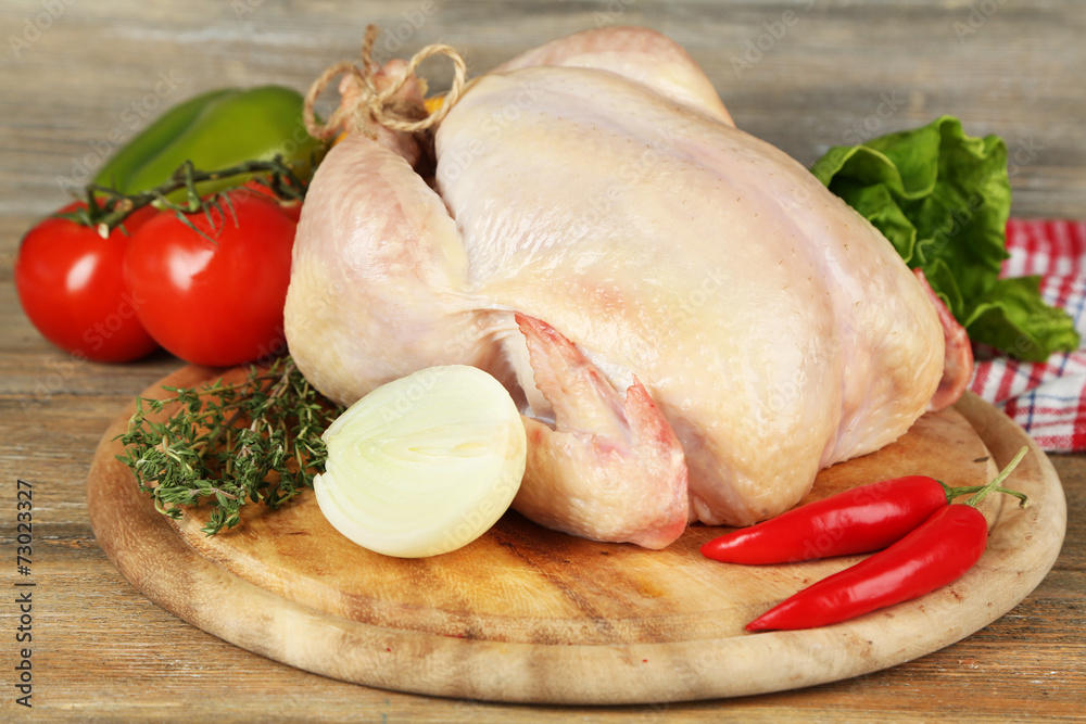 Raw chicken on wooden table Raw chicken on wooden table