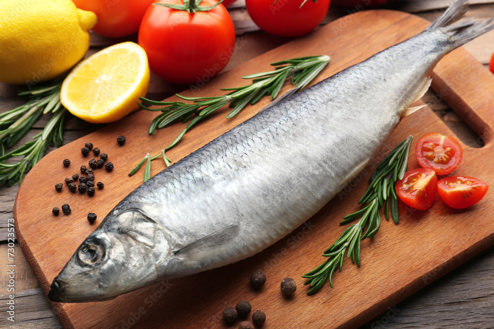 Fresh raw fish and food ingredients on table Fresh raw fish and food ingredients on table