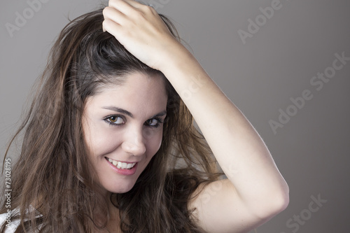 Portrait of a young brunette woman making faces with different e