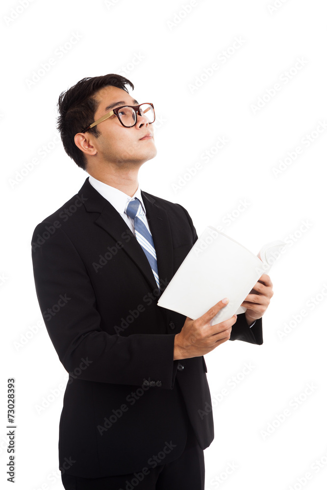 Asian businessman read a book imagine of something Asian businessman read a book imagine of something
