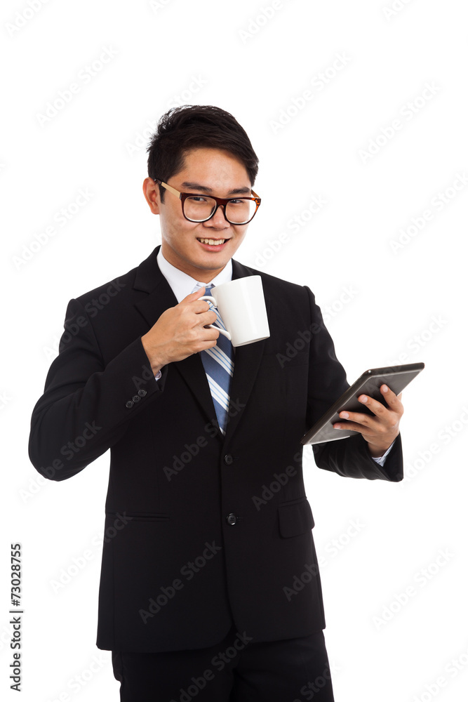 Asian businessman with a cup of coffee and tablet PC Asian businessman with a cup of coffee and tablet PC