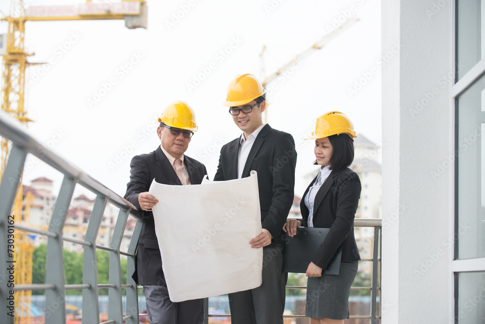 asian architect team in discussion on worksite asian architect team in discussion on worksite