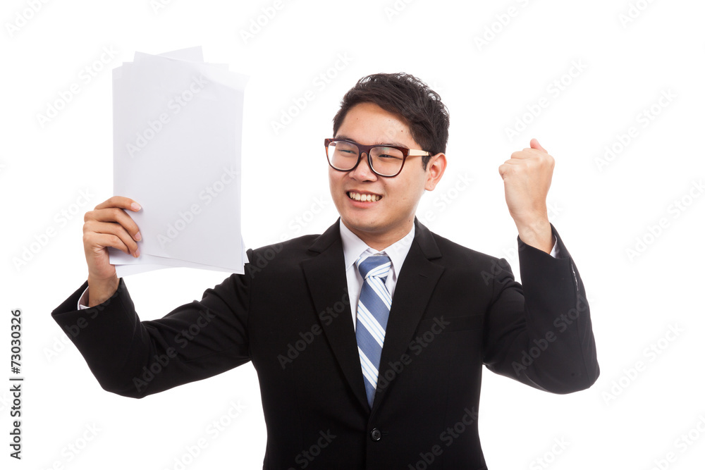 Asian businessman happy with success with report paper Asian businessman happy with success with report paper