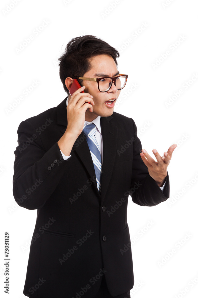 Angry Asian businessman talk on mobile phone Angry Asian businessman talk on mobile phone