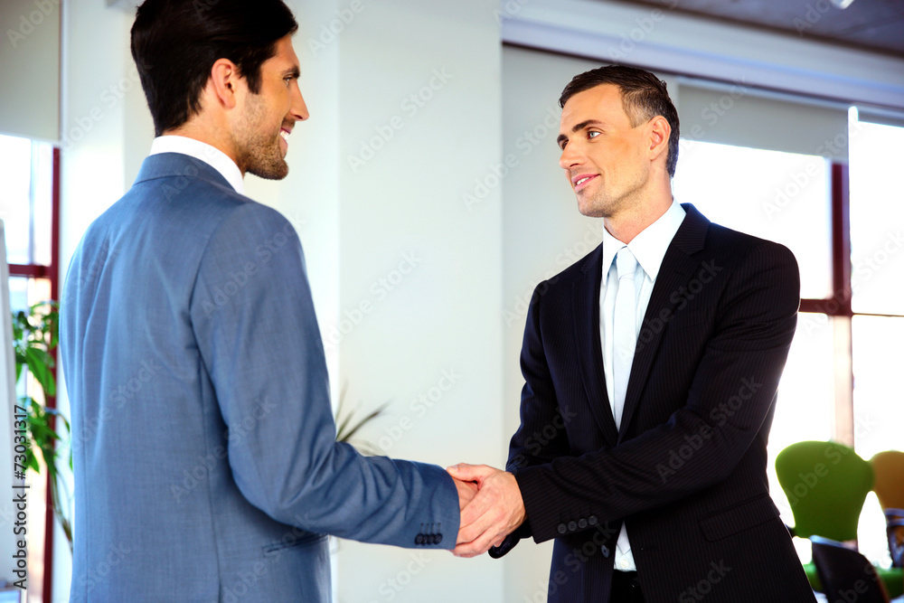 Two smiling businessman handshaking Two smiling businessman handshaking