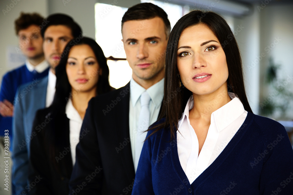 Group of a business people standing lined up in the office Group of a business people standing lined up in the office