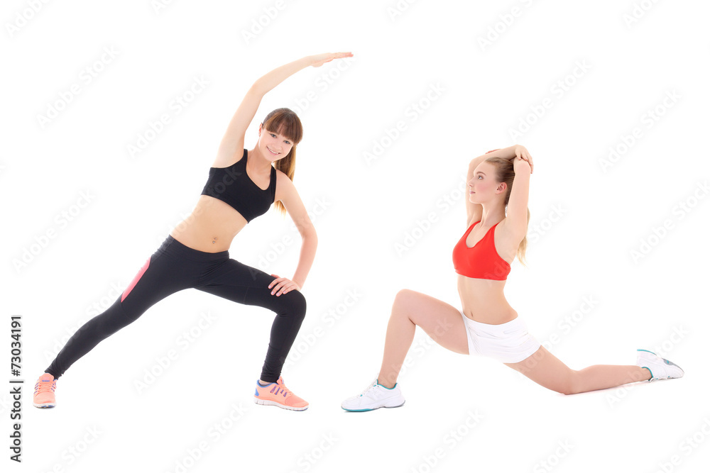 two slim sporty women doing stretching exercises isolated on whi two slim sporty women doing stretching exercises isolated on whi