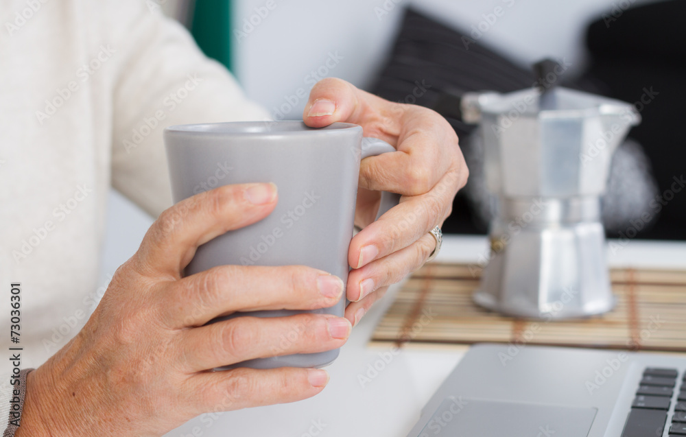Woman holding cup of coffee Woman holding cup of coffee
