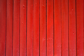  Red painted wooden fence panels.