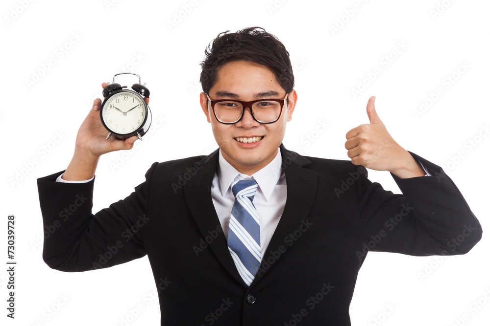 Asian businessman thumbs up with alarm clock Asian businessman thumbs up with alarm clock