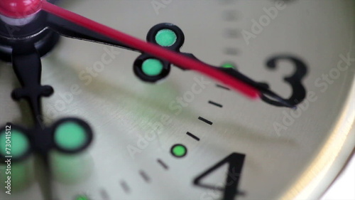 A close up of clock with second hand moving photo