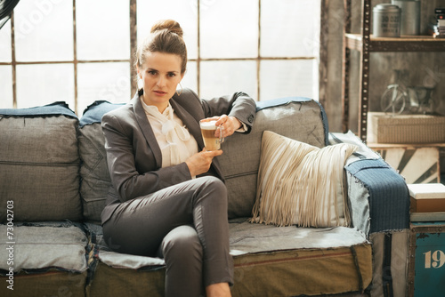 Business woman with coffee latte in loft apartment