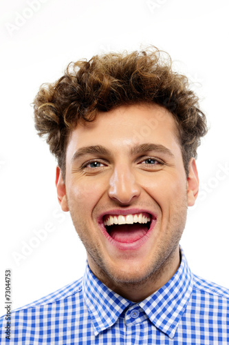 Portrait of a young laughing man on white background © Drobot Dean