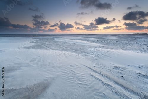 sunrise over sand beach on North sea