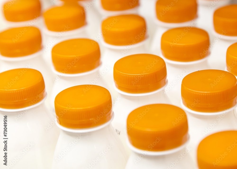 Rows with bottles of milk on the supermarket shelves Rows with bottles of milk on the supermarket shelves