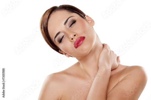 young woman stretch her neck and massaged it with her hand