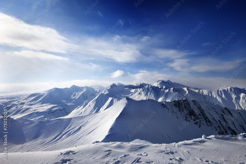Snowy mountains and sunlight sky