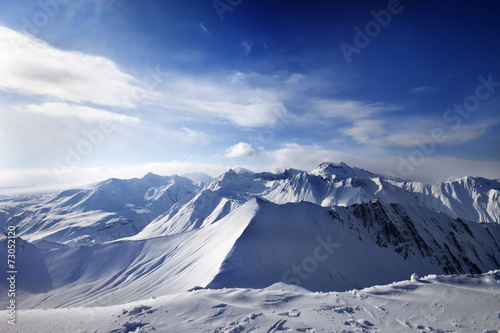 Snowy mountains and sunlight sky © BSANI