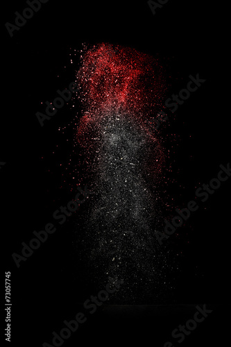 Stop motion of white and red dust explosion isolated on black ba