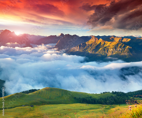 View of the foggy Val di Fassa valley with passo Sella. National photo