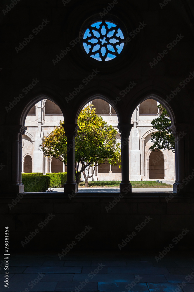 Courtyard of Alcobaca Monastery seen through a window