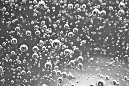 Air bubbles in water. Abstract black-and-white background. Macro