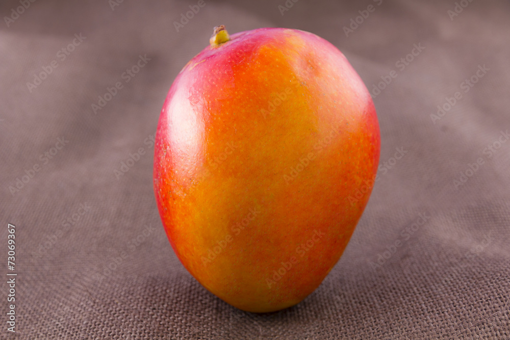 Mango fruit isolated on brown background Mango fruit isolated on brown background