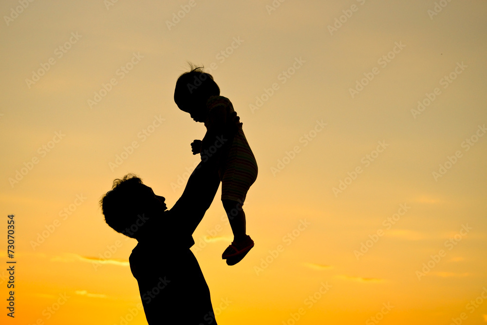 father holding and raising his son silhouette