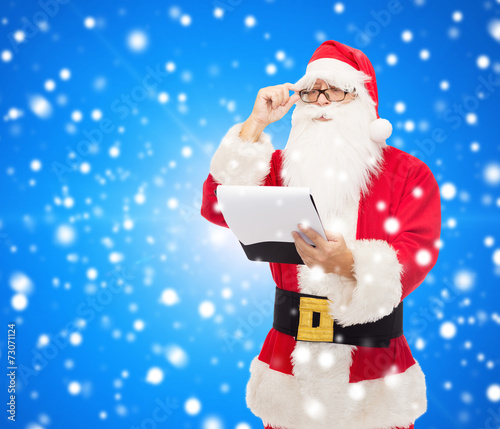man in costume of santa claus with notepad © Syda Productions