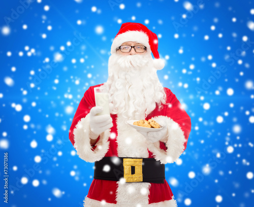 santa claus with glass of milk and cookies © Syda Productions
