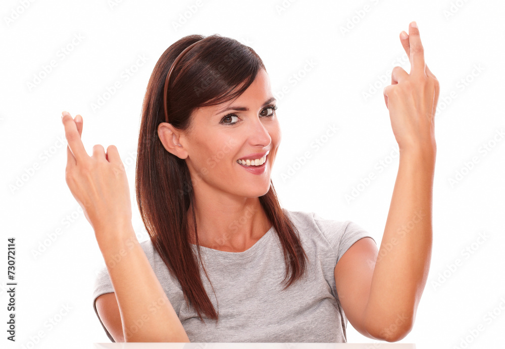 Attractive lady with luck sign looking at camera Attractive lady with luck sign looking at camera